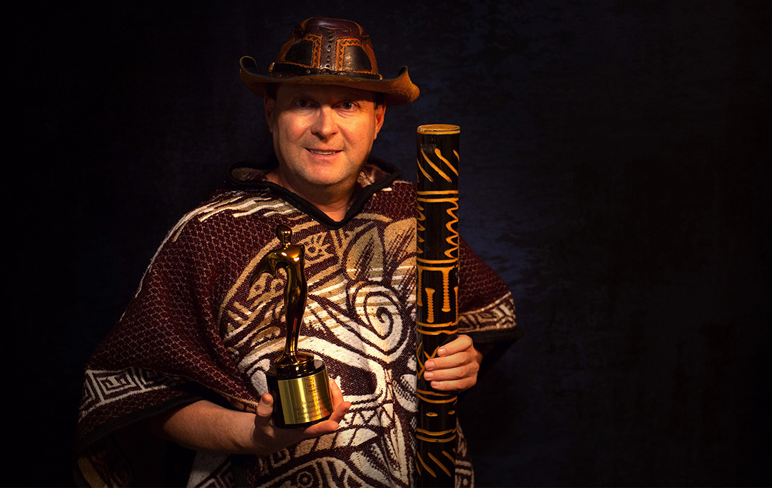 Arek Zasowski holding Gold Telly Award and tribal staff, winner of Film & Shorts – 3D Animation, Guardians of the Secrets of the Luminara Challenge