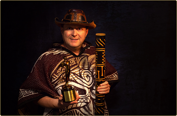 Arek Zasowski with his Gold Telly Award for Guardians of the Secrets of the Luminara Challenge Arek Zasowski holding Gold Telly Award statuette and jungle-inspired prop, award-winning actor director producer of Guardians of the Secrets of the Luminara Challenge